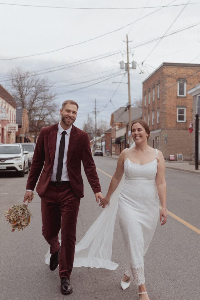 The bride and groom walking through the streets of Merrickville, Ontario.