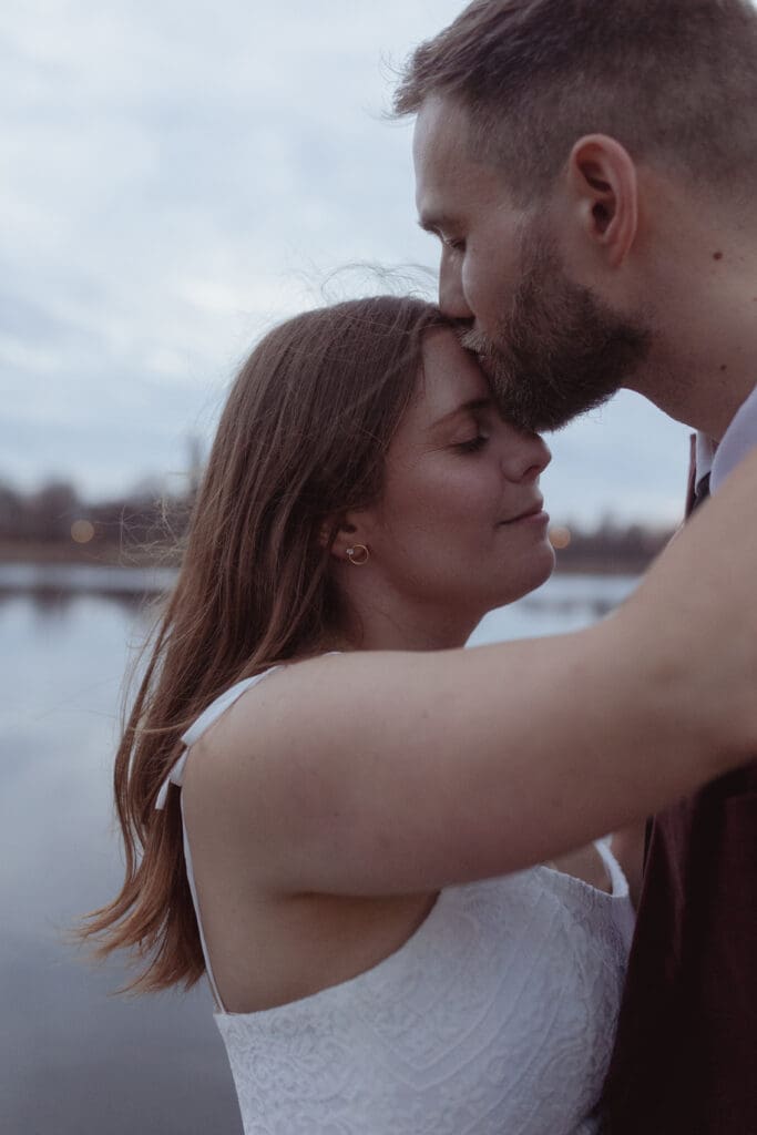 The bride and groom embracing at the Rideau Canal in Merrickville, Ontario, and the Rideau Canal.
